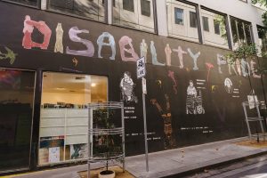 A colourful mural that reads Disability Pride