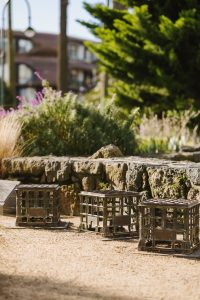 3 Bronze milk crates in a park