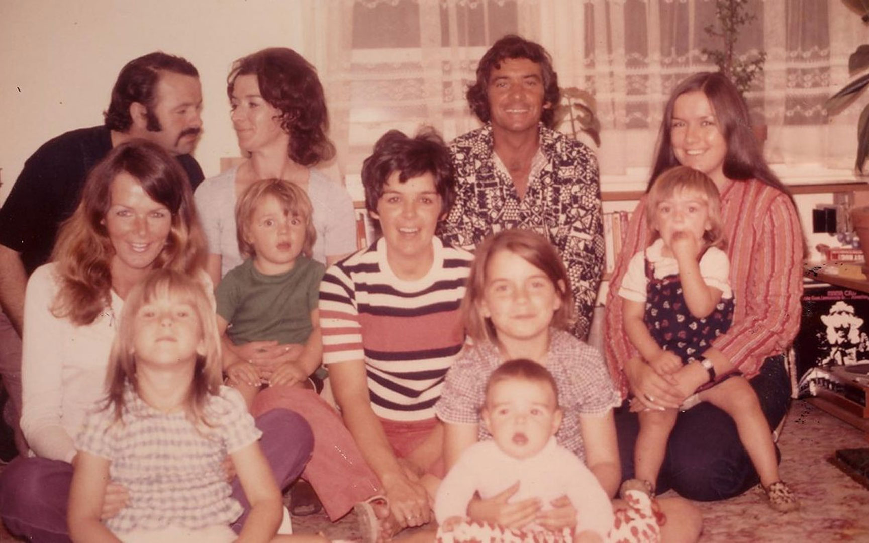 A picture of a large family, all smiling towards the camera.