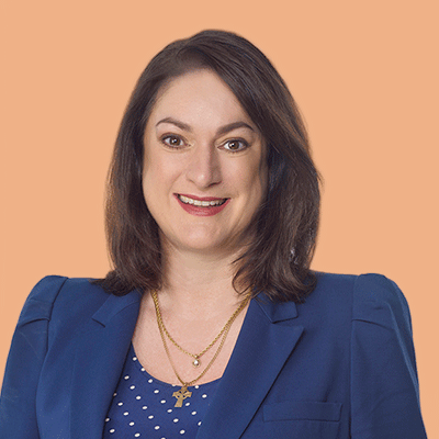 Maree Davenport portrait, in a blue suit and smiling to camera