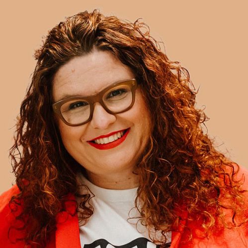 Tanja wearing glasses and smiling to camera