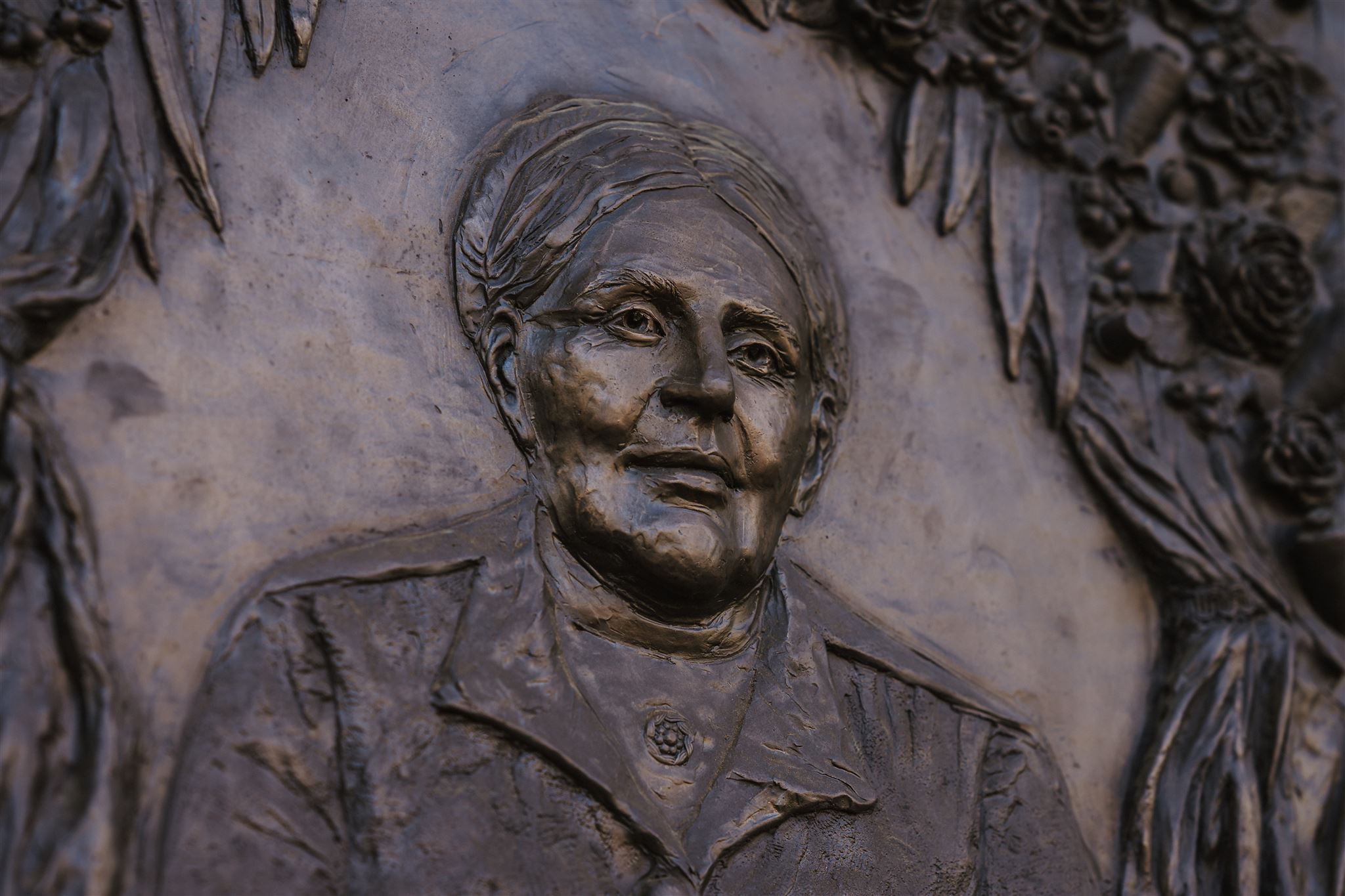 Bronze Sculpture of a a woman wearing a coat